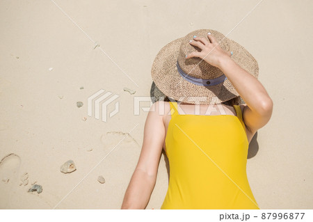 Woman tourist in yellow swimsuit and hat, happy traveler sunbathing at Paradise beach on Islands. destination, wanderlust, Asia Travel, tropical summer, vacation and holiday concept Woman tourist in yellow swimsuit and hat, happy traveler sunbathing at Paradise beach on Islands. destination, wanderlust, Asia Travel, tropical summer, vacation and holiday concept 87996877