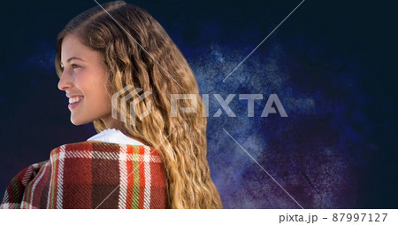 Side view of a caucasian woman smiling against copy space on textured blue background 87997127