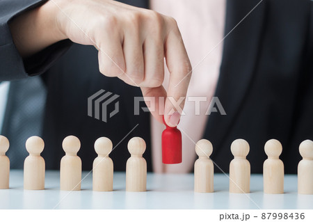 Businesswoman hand pulling leader man wooden from crowd of employees. Toxic People, Human resource management, Recruitment, Teamwork and leadership Concepts Businesswoman hand pulling leader man wooden from crowd of employees. Toxic People, Human resource management, Recruitment, Teamwork and leadership Concepts 87998436