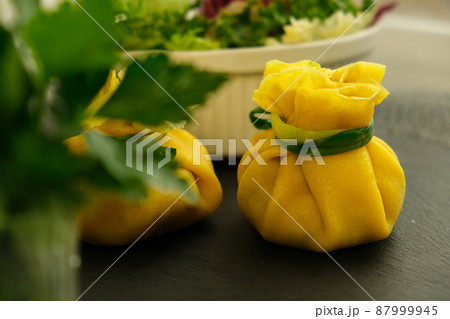 Pancakes. Yellow stuffed bliny with mushrooms and sour cream. Light background. Beautiful and delicious breakfast at home or in a cafe. Selective focus. Concept: Shrovetide menu. Slavic maslenitsu 87999945