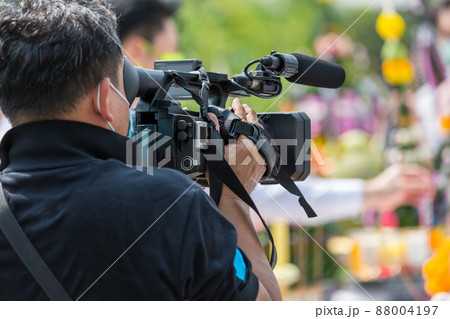 Video camera operator working with his equipment. video cinema production. 88004197