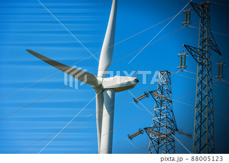 Wind Turbine and High Voltage Towers against a Clear Sky - Renewable Energy 88005123