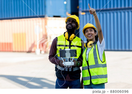 Foreman or worker use remote controller piloting drone  88006096