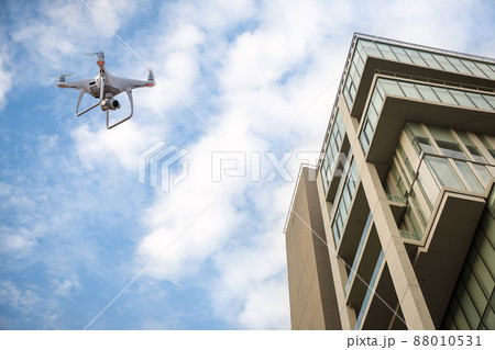 Drone with high resolution digital camera flying over city Drone with high resolution digital camera flying over city 88010531