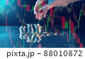Multilayered display with stock charts and a pile of coins 88010872