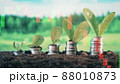 Coins with plants and live stock charts on a multilayered screen 88010873