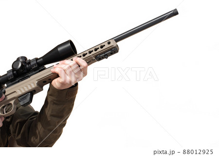 A sniper rifle with an optical sight in man`s hands A sniper rifle with an optical sight in man`s hands 88012925