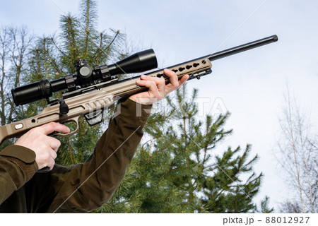 A sniper rifles from a rifle with an optical sight in man`s hands winter day A sniper rifles from a rifle with an optical sight in man`s hands winter day 88012927