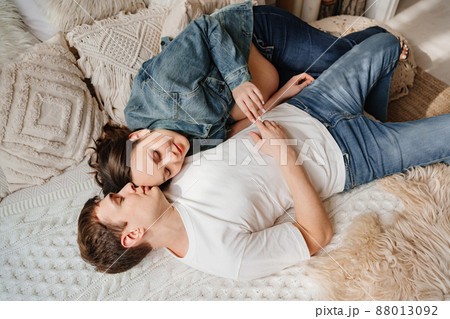 top view. pregnant woman and man. a couple in the bed. parenthood top view. pregnant woman and man. a couple in the bed. parenthood 88013092