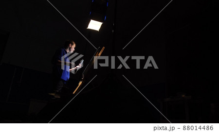 Artist copyist paint seascape with ship in ocean. Craftsman decorator draw as boat sail on blue sea. Black background. Wide angle shot. 88014486