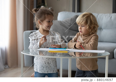 Happy cute little kids siblings drawing pictures at home. 88014697