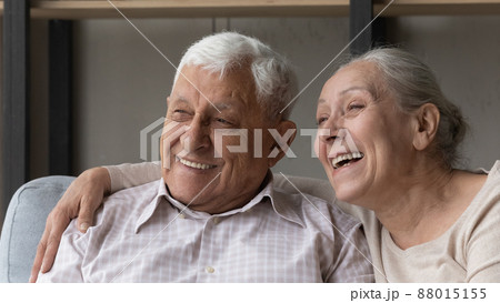 Closeup portrait happy older spouses smile look into distance 88015155