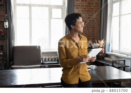 Happy young African entrepreneur woman holding tablet computer Happy young African entrepreneur woman holding tablet computer 88015700