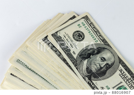 a skewed stack of old us dollar banknotes on white background - close shot a skewed stack of old us dollar banknotes on white background - close shot 88016907