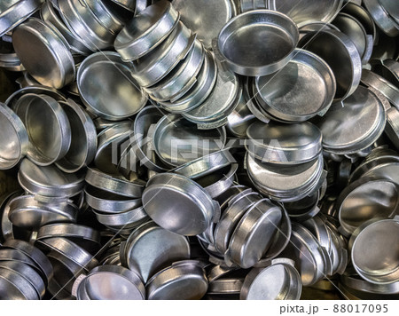 batch of olod stamped shiny metal caps, selective focus top-down wiew batch of olod stamped shiny metal caps, selective focus top-down wiew 88017095