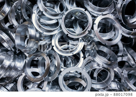 a batch of machined shiny metal parts with selective focus 88017098