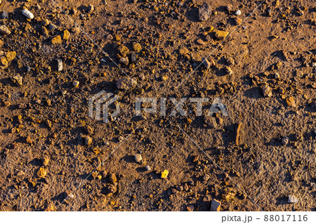 abstract dry mud background with small rocks and selective focus 88017116