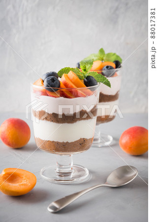 Apricot trifle, chocolate biscuit, layered dessert with fresh berry and gentle cream cheese. 88017381