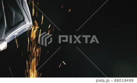 Forge workshop. Smithy manual production. Close up details of sparks, industrial worker using angle grinder and cutting steel. Forge workshop. Smithy manual production. Close up details of sparks, industrial worker using angle grinder and cutting steel. 88018499