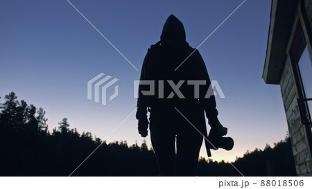 Silhouette traveler photographing scenic view in forest, river. Wood pier. One woman shooting nice dark magic night look. Girl take photo on camera. Silhouette traveler photographing scenic view in forest, river. Wood pier. One woman shooting nice dark magic night look. Girl take photo on camera. 88018506