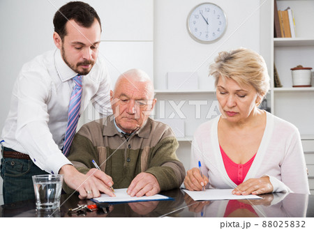 couple signing papers in bank 88025832