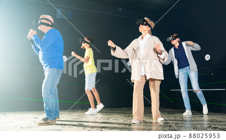 Family using virtual reality glasses delighted with videogames Family using virtual reality glasses delighted with videogames 88025953