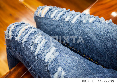 leg of women in fragmentary and torn jeans leg of women in fragmentary and torn jeans 88027299