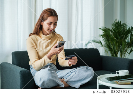 Woman using shopping application on smartphone and payment by credit card. Woman using shopping application on smartphone and payment by credit card. 88027918