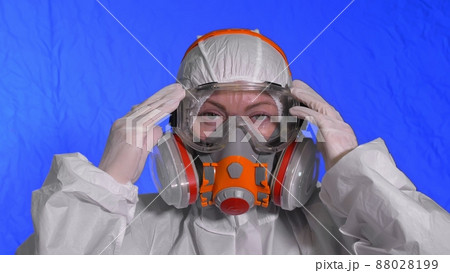Scientist virologist in respirator. Woman close up look, wearing protective medical mask. Concept health safety N1H1 coronavirus epidemic 2019 nCoV. Scientist virologist in respirator. Woman close up look, wearing protective medical mask. Concept health safety N1H1 coronavirus epidemic 2019 nCoV. 88028199