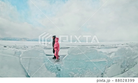 Couple has fun during winter walk against background of ice of f 88028399