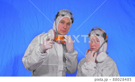 Doctor health worker in respirator. Slow motion. People portrait, wearing protect medical antibacterial antiviral aerosol spray paint mask. 88028485