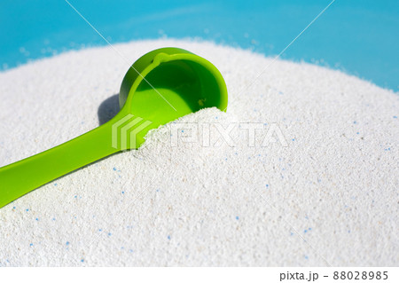 Detergent powder with measuring spoon for clothes washing. Laundry concept. Detergent powder with measuring spoon for clothes washing. Laundry concept. 88028985