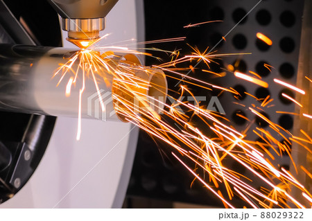 Laser cutting machine working with cylindrical metal workpiece with sparks 88029322