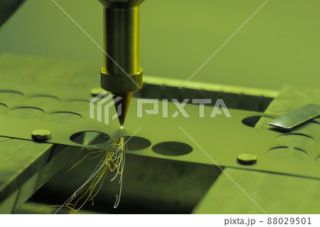 Automatic laser cutting machine working with sheet metal with sparks - close up Automatic laser cutting machine working with sheet metal with sparks - close up 88029501