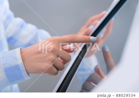 Close up: woman using touchscreen display of interactive kiosk at exhibition 88029534