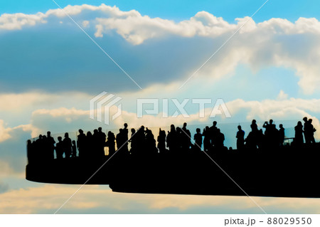 Unrecognizable people silhouettes walking on floating pedestrian bridge Unrecognizable people silhouettes walking on floating pedestrian bridge 88029550