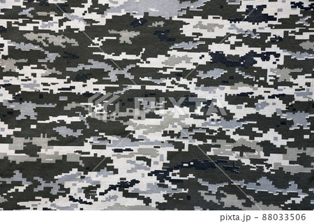 Fabric with texture of Ukrainian military pixeled camouflage. Cloth with camo pattern in grey, brown and green pixel shapes. Official uniform of Ukrainian soldiers Fabric with texture of Ukrainian military pixeled camouflage. Cloth with camo pattern in grey, brown and green pixel shapes. Official uniform of Ukrainian soldiers 88033506