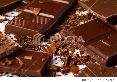 Grated chocolate and pieces of tasty chocolate on table 88034797
