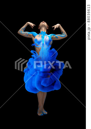 Portrait of young beautiful woman covered with black thick pain and dye splash dancing isolated over black background Portrait of young beautiful woman covered with black thick pain and dye splash dancing isolated over black background 88036613