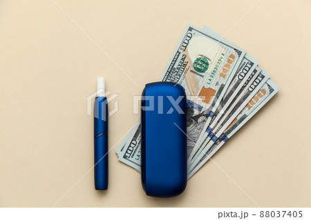 Iqos electronic blue cigarette on a beige background. Iqos electronic blue cigarette on a beige background. 88037405