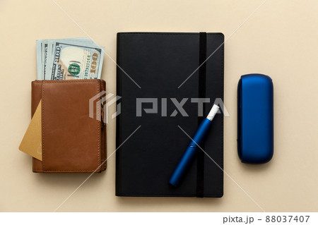 Iqos electronic blue cigarette on a beige background. Iqos electronic blue cigarette on a beige background. 88037407