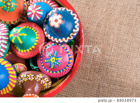 Pottery tips stacked in a pottery bowl on sackcloth background 88038973