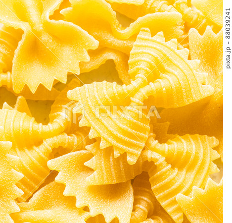 background from uncooked farfalle pasta pieces background from uncooked farfalle pasta pieces 88039241