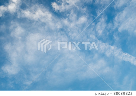 Light blue sky with white clouds. Creative sky background for celebration and season decoration. A backing of vanilla sky for branding, calendar, multicolor card, banner, cover, website. A place for 88039822