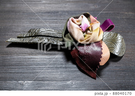 leather and silk brooch as rose flower close up 88040170