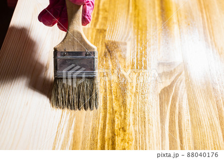 wooden board is covered with wood stain close up 88040176