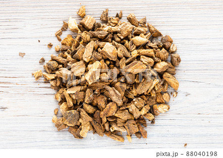pile of dried burdock roots on gray wooden board pile of dried burdock roots on gray wooden board 88040198