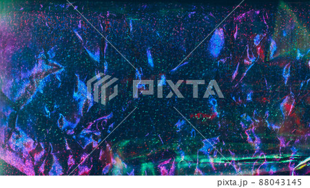 Crumpled holographic foil texture. Shiny glitter multicolor background 88043145