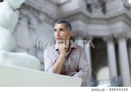 Adult man is visiting museum and looking at the exposition 88044349
