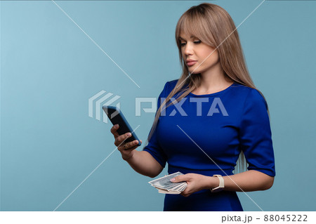 Financially savvy girl using cell phone Financially savvy girl using cell phone 88045222